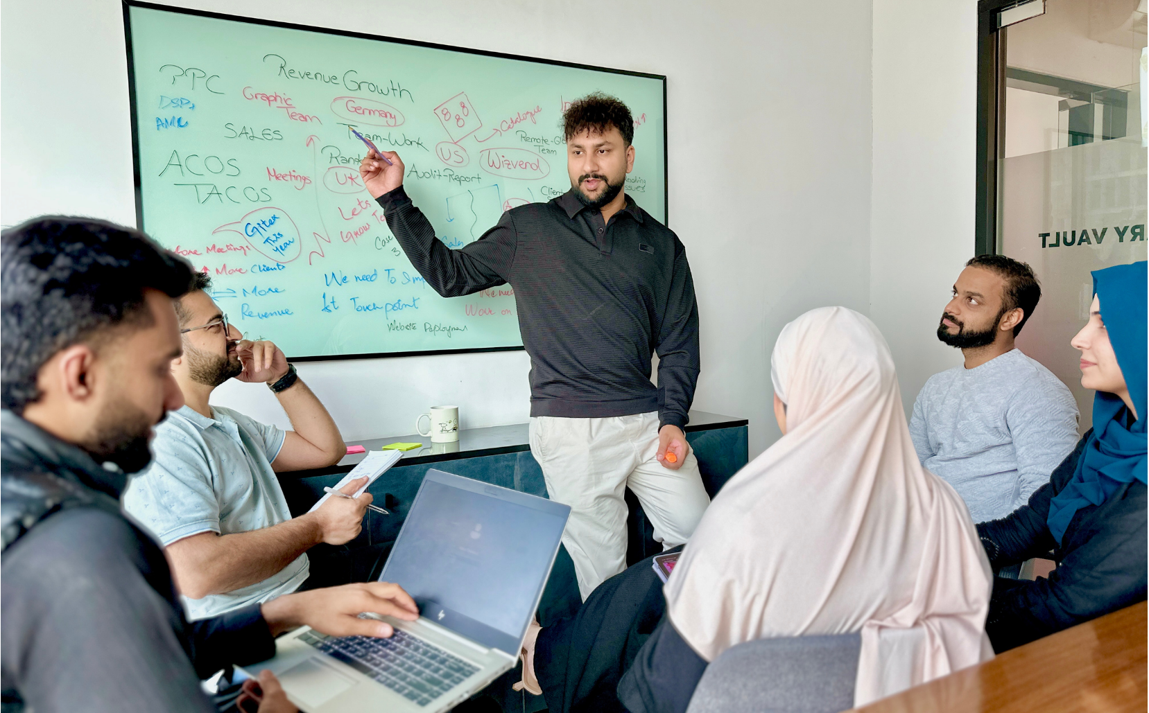 People discussing at whiteboard